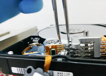 picture of a tech repairing a hard drive